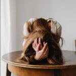 frustrated woman lying on table