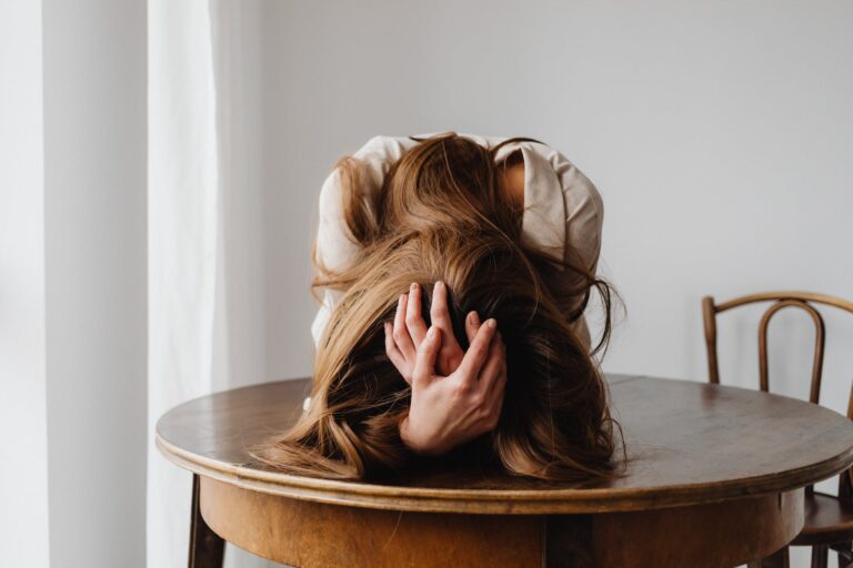 frustrated woman lying on table